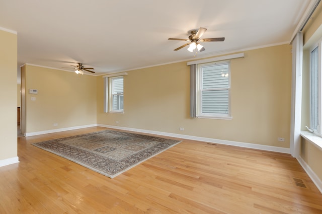 empty room with light hardwood / wood-style floors, ceiling fan, and crown molding