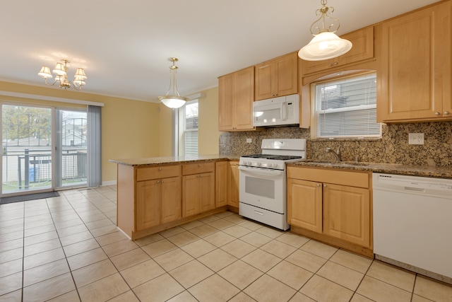 kitchen with backsplash, kitchen peninsula, pendant lighting, white appliances, and light brown cabinetry