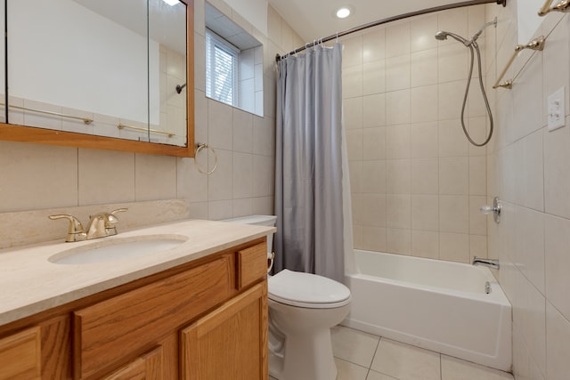 full bathroom with vanity, tile patterned floors, toilet, tile walls, and shower / tub combo with curtain