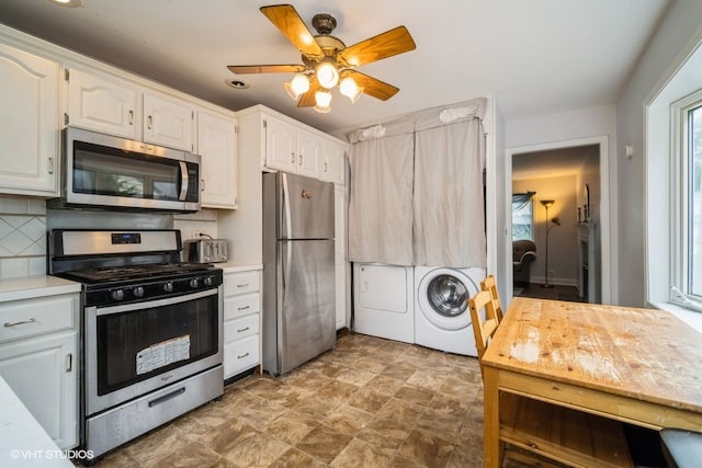 kitchen featuring white cabinetry, ceiling fan, stainless steel appliances, tasteful backsplash, and washer and dryer