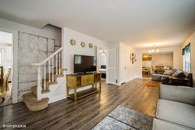 living room with dark hardwood / wood-style floors and a chandelier