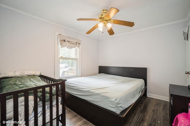 bedroom with ceiling fan, crown molding, and dark wood-type flooring