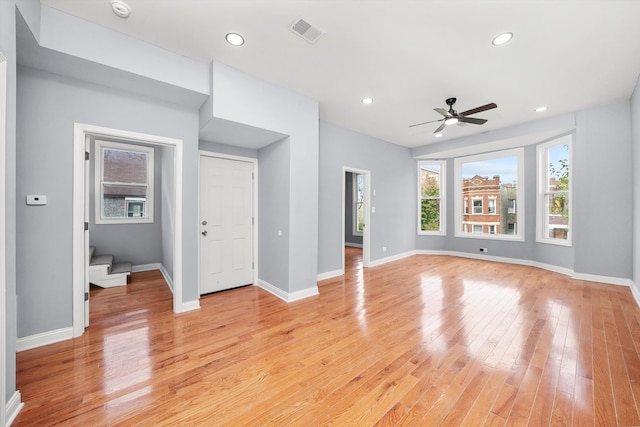 unfurnished living room with ceiling fan and light wood-type flooring