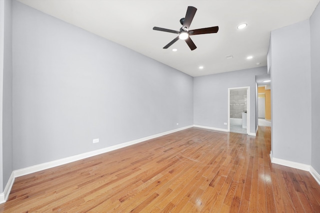 empty room with ceiling fan and light hardwood / wood-style floors