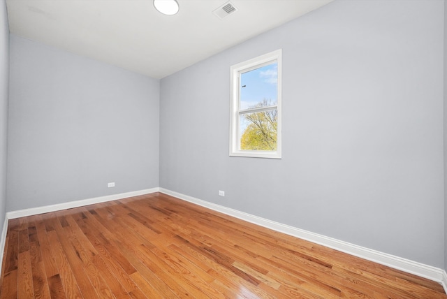 empty room with hardwood / wood-style floors