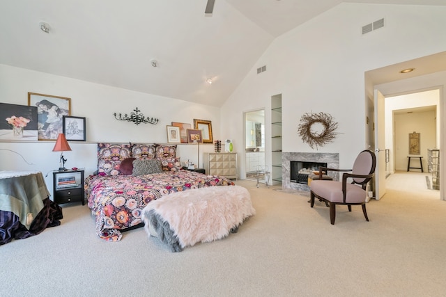 carpeted bedroom with ceiling fan, a fireplace, and high vaulted ceiling