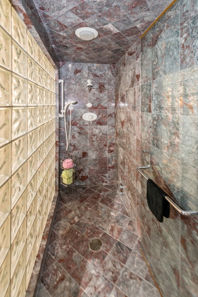 bathroom with a tile shower