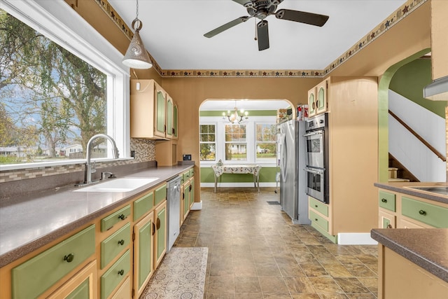 kitchen with pendant lighting, a wealth of natural light, sink, and appliances with stainless steel finishes