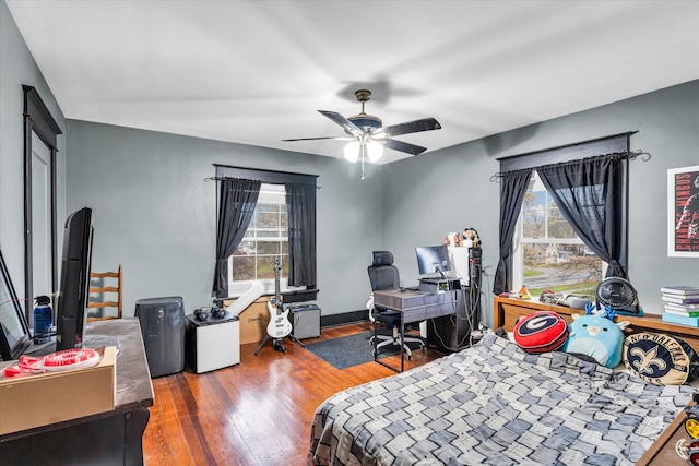 bedroom featuring dark hardwood / wood-style flooring and ceiling fan