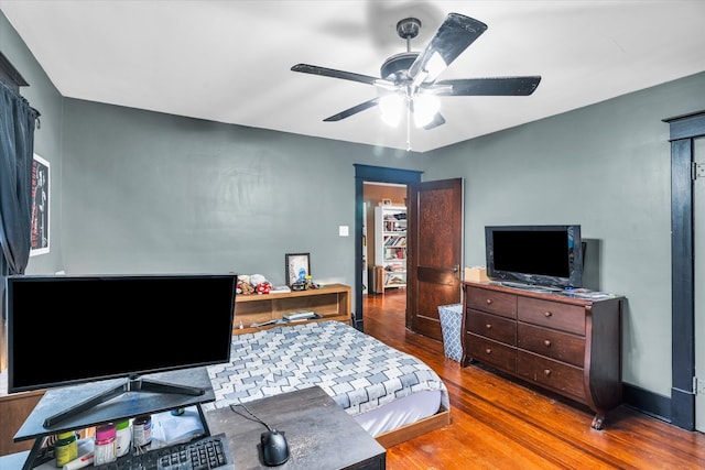 bedroom with hardwood / wood-style floors and ceiling fan