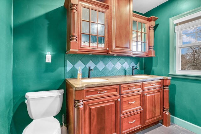 bathroom with tile patterned floors, decorative backsplash, toilet, and vanity