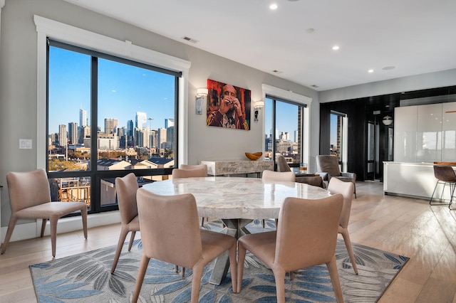 dining space featuring a wealth of natural light and light hardwood / wood-style floors