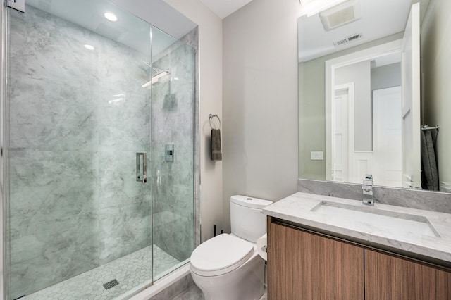 bathroom featuring walk in shower, vanity, and toilet