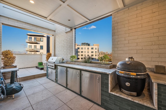 view of patio with an outdoor kitchen and a grill