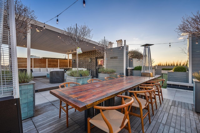 deck at dusk with an outdoor living space