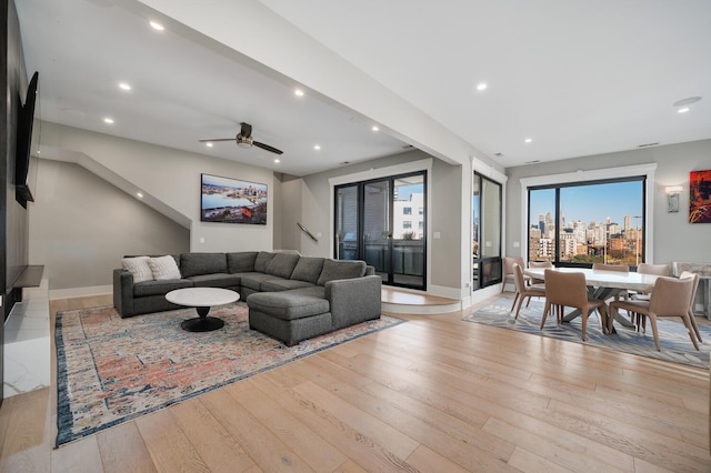 living room featuring ceiling fan and light wood-type flooring