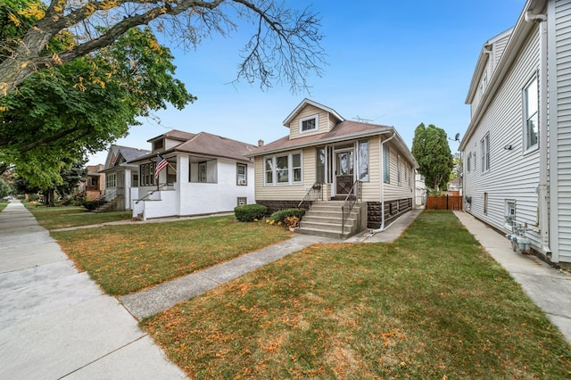 bungalow-style house featuring a front lawn