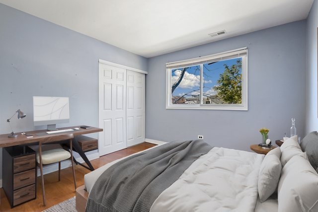 bedroom featuring hardwood / wood-style floors and a closet