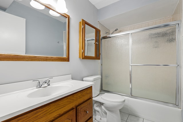 full bathroom featuring tile patterned flooring, vanity, toilet, and shower / bath combination with glass door