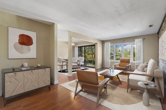 sitting room featuring plenty of natural light and wood-type flooring