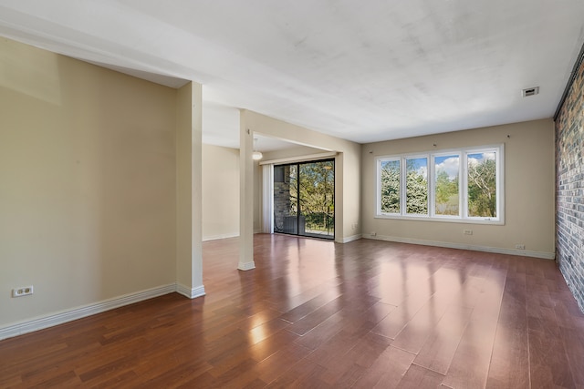 unfurnished room featuring hardwood / wood-style flooring and plenty of natural light