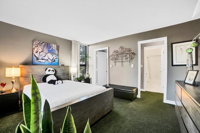 bedroom with ensuite bath and dark colored carpet