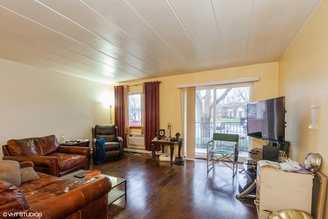 living room featuring dark wood-style flooring and a wealth of natural light