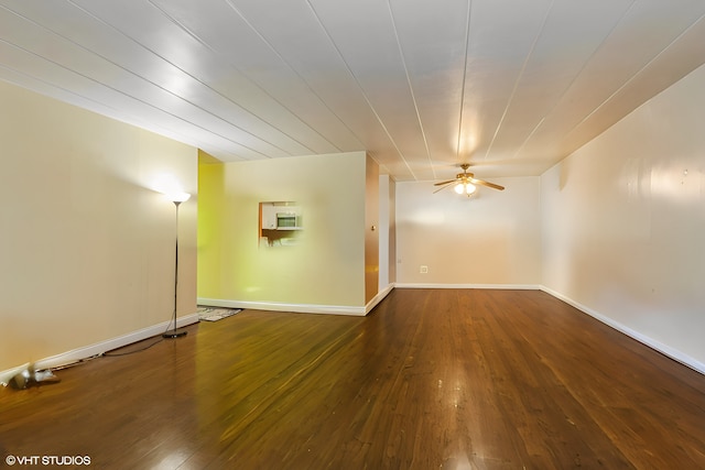 unfurnished room featuring ceiling fan, hardwood / wood-style floors, and baseboards