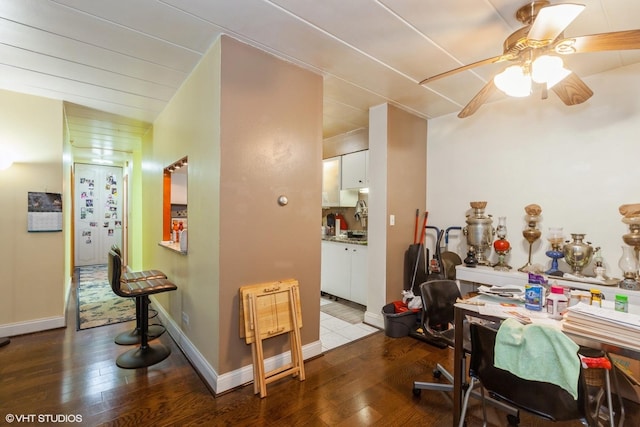 office space with wood-type flooring, baseboards, and ceiling fan