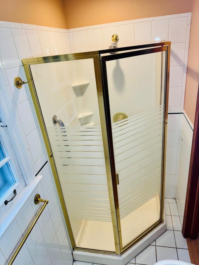 bathroom with tile patterned flooring and walk in shower