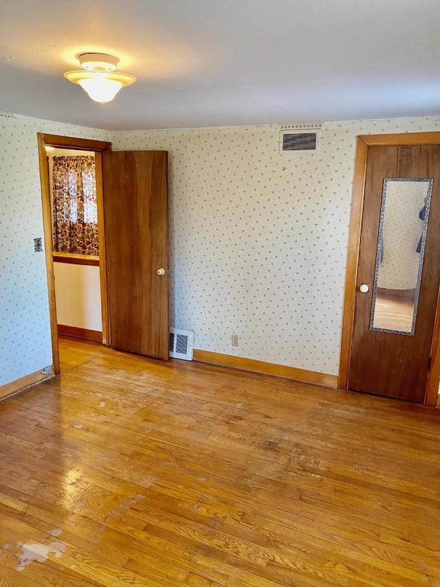 spare room with light hardwood / wood-style flooring