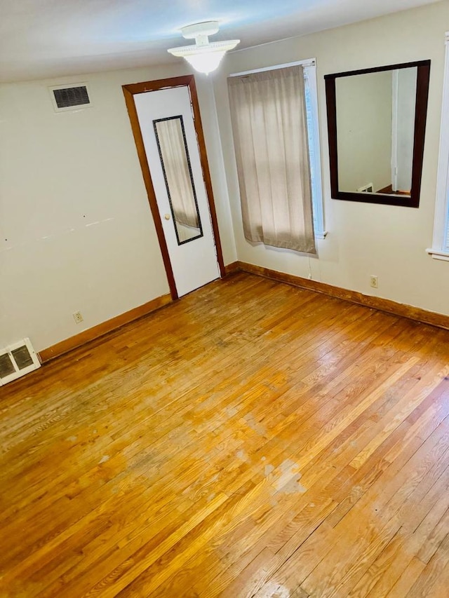 unfurnished room with light hardwood / wood-style flooring