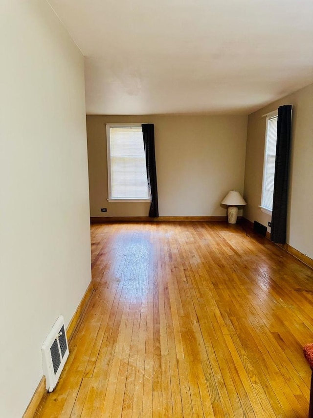 spare room with light hardwood / wood-style floors