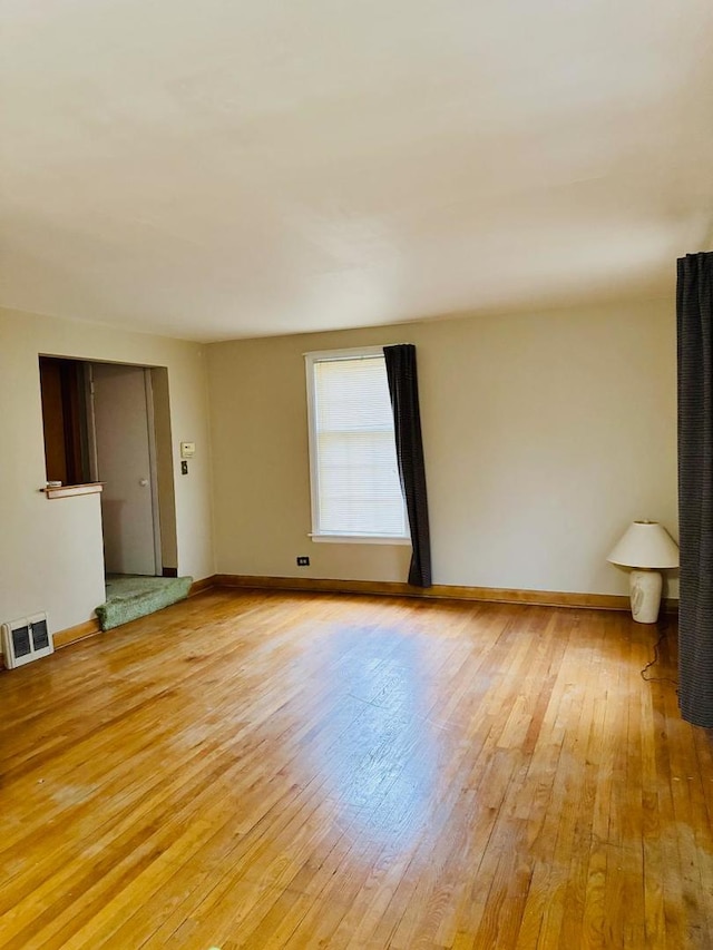 empty room with light hardwood / wood-style floors