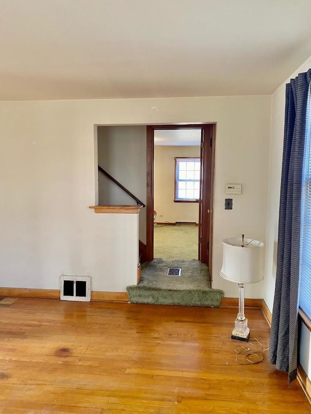 spare room with hardwood / wood-style floors