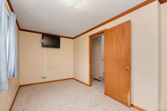 interior space featuring crown molding and a textured ceiling