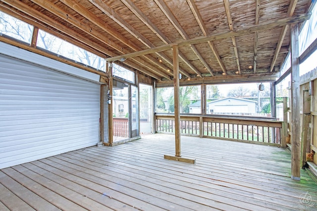 wooden deck featuring an outdoor structure and a garage