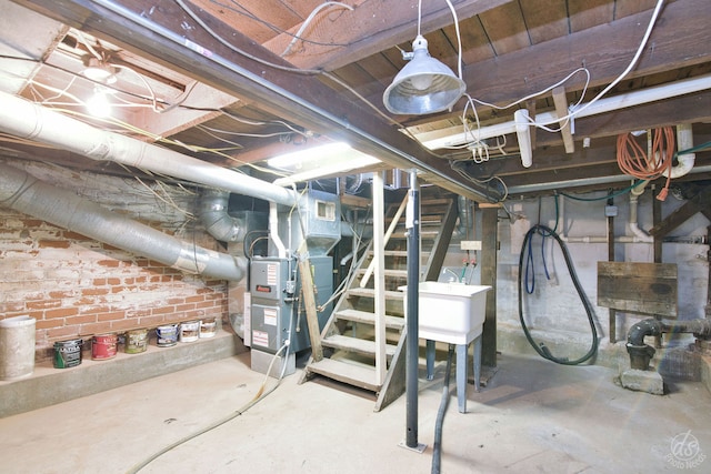 basement with heating unit and sink