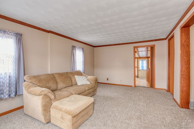 carpeted living room featuring a wealth of natural light, a textured ceiling, and ornamental molding