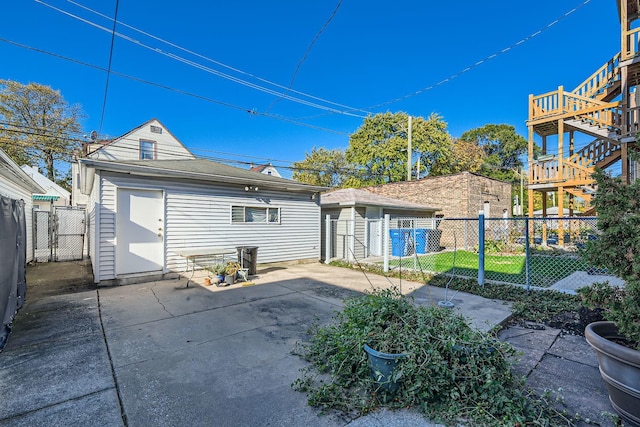 rear view of property featuring a yard, a patio area, and an outdoor structure