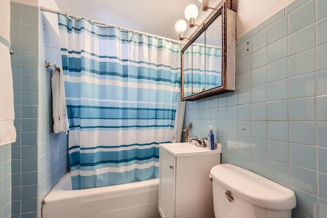 full bathroom with toilet, tile walls, vanity, shower / bath combo with shower curtain, and backsplash