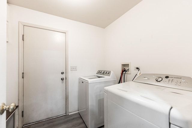 washroom featuring dark hardwood / wood-style floors and washing machine and dryer