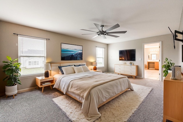 bedroom with ensuite bath, ceiling fan, and carpet