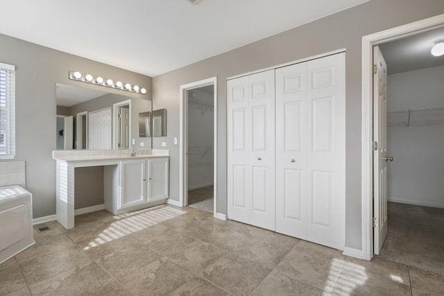 bathroom with vanity and a bath