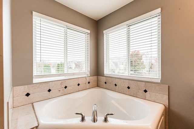 bathroom with a healthy amount of sunlight and a tub