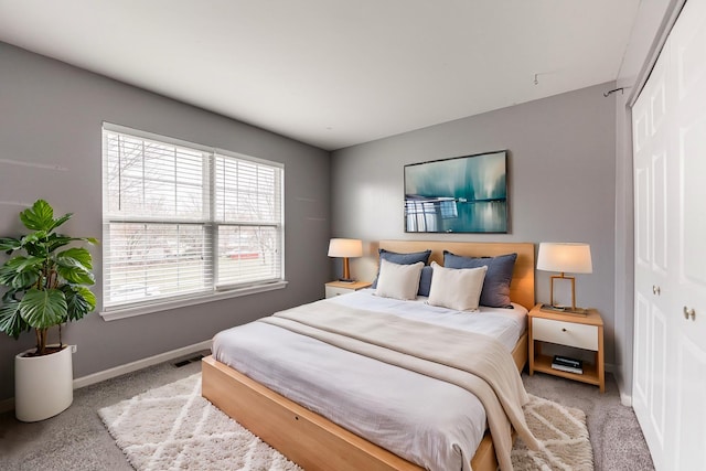 bedroom featuring light colored carpet and a closet