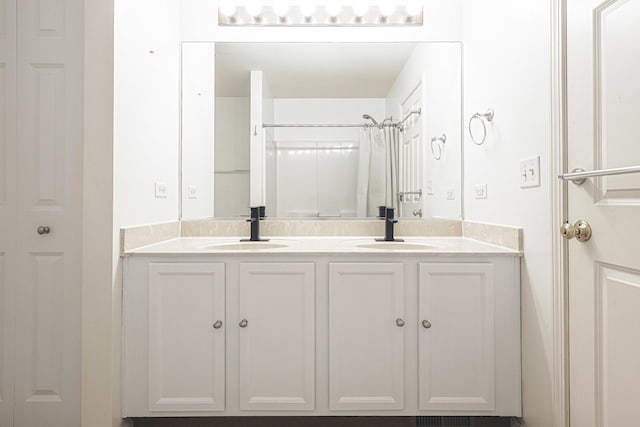 bathroom with walk in shower and vanity