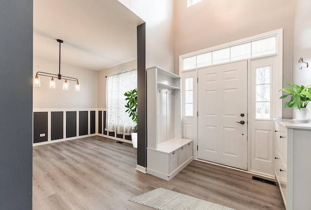 foyer with a chandelier and light hardwood / wood-style flooring