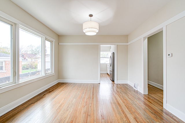 unfurnished dining area with a wealth of natural light and light hardwood / wood-style flooring