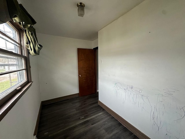 unfurnished room with dark hardwood / wood-style floors